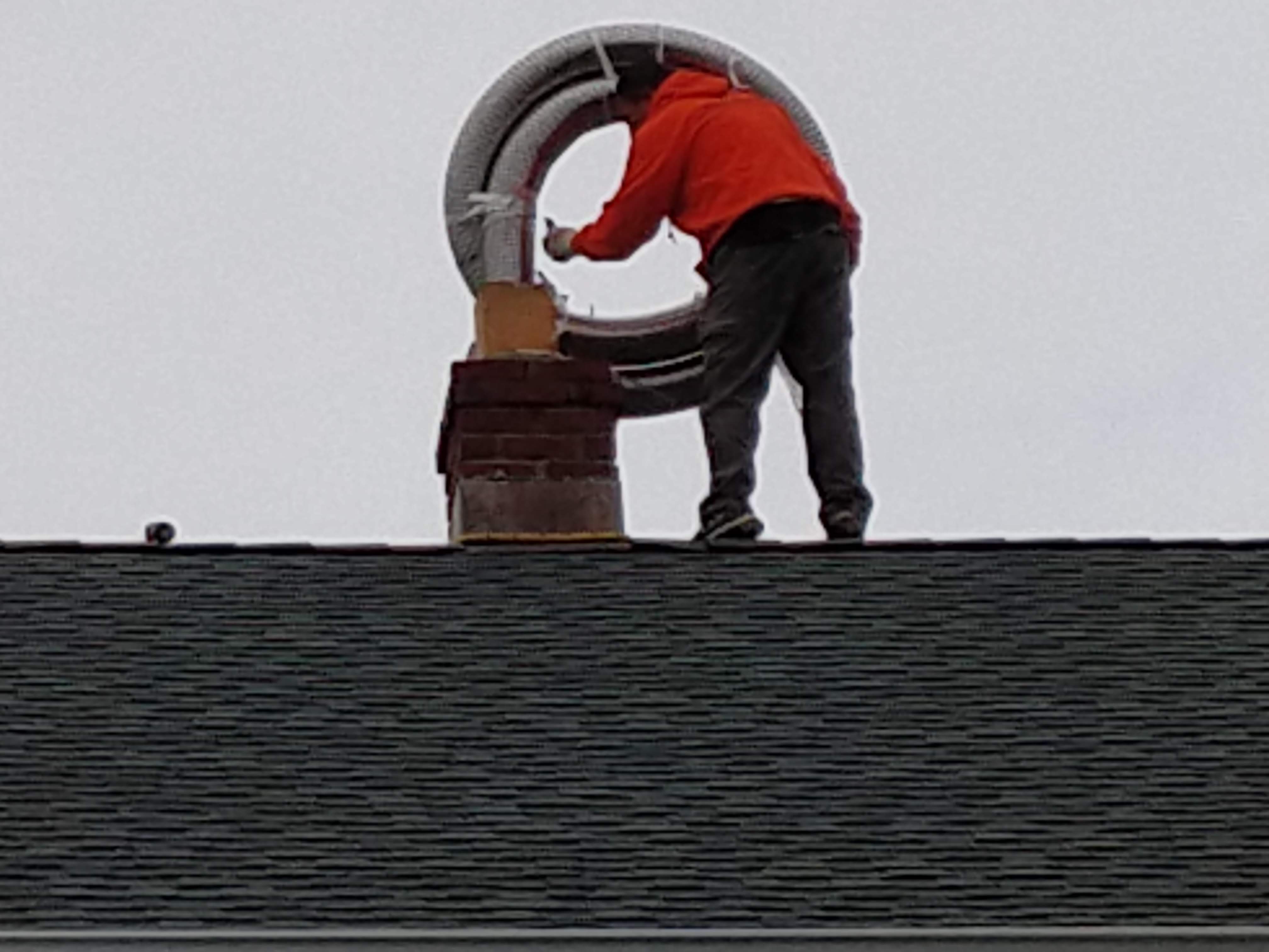 Flexible stainless chimney liner being installed in Dix Hills, New York